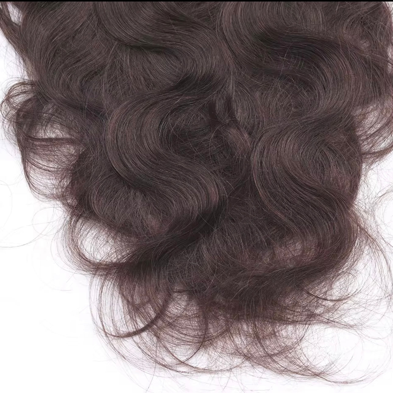 Close-up of raqlyn wavy dark brown hair on a white background